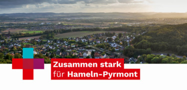Im Hintergrund das Weserbergland und davor das Logo "Zusammen stark für Hameln-Pyrmont".